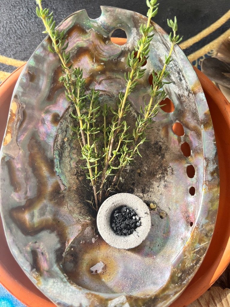 A smudging bowl with sacred herbs