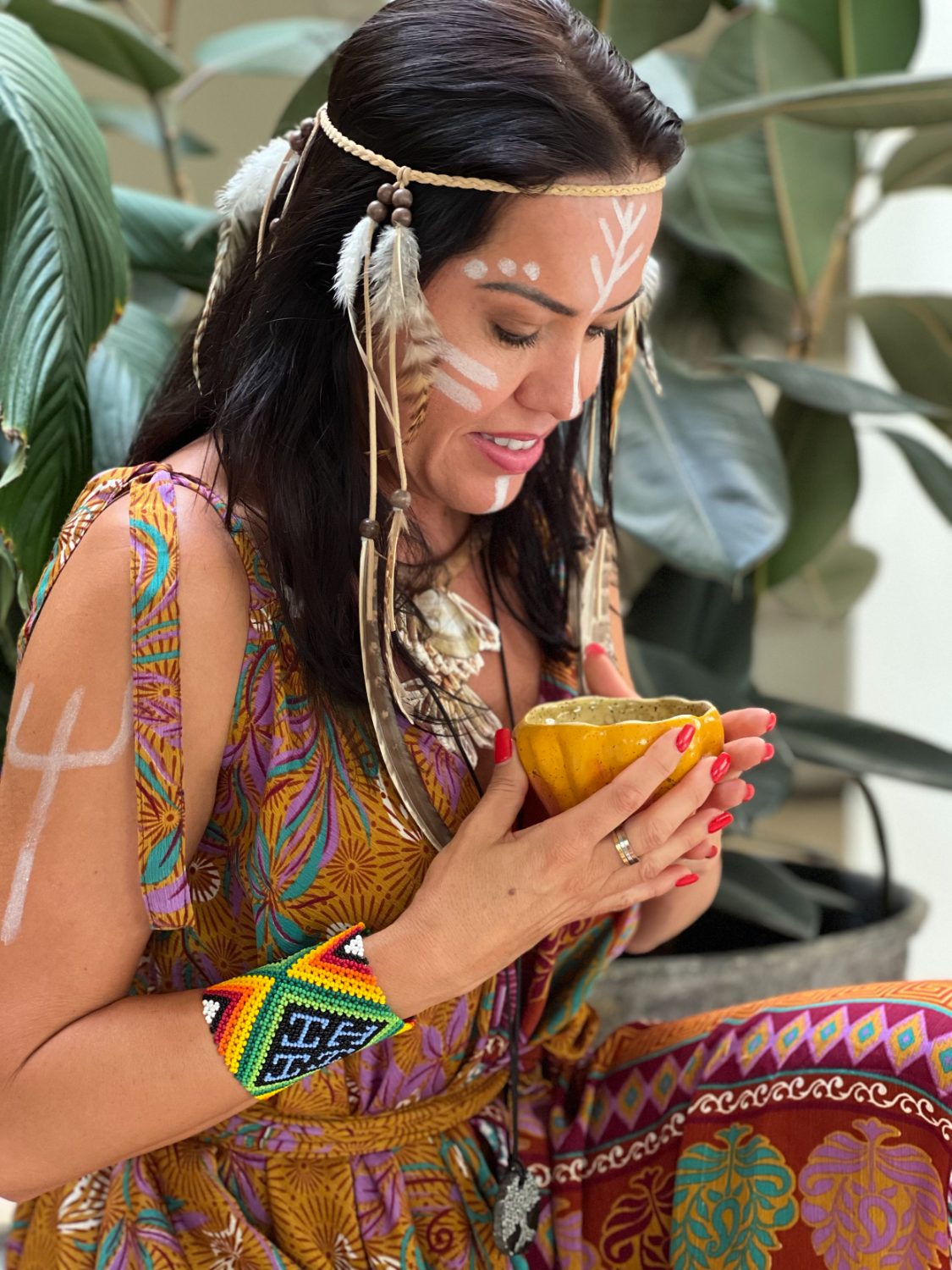 Márcia holding a cup of ceremonial cacao